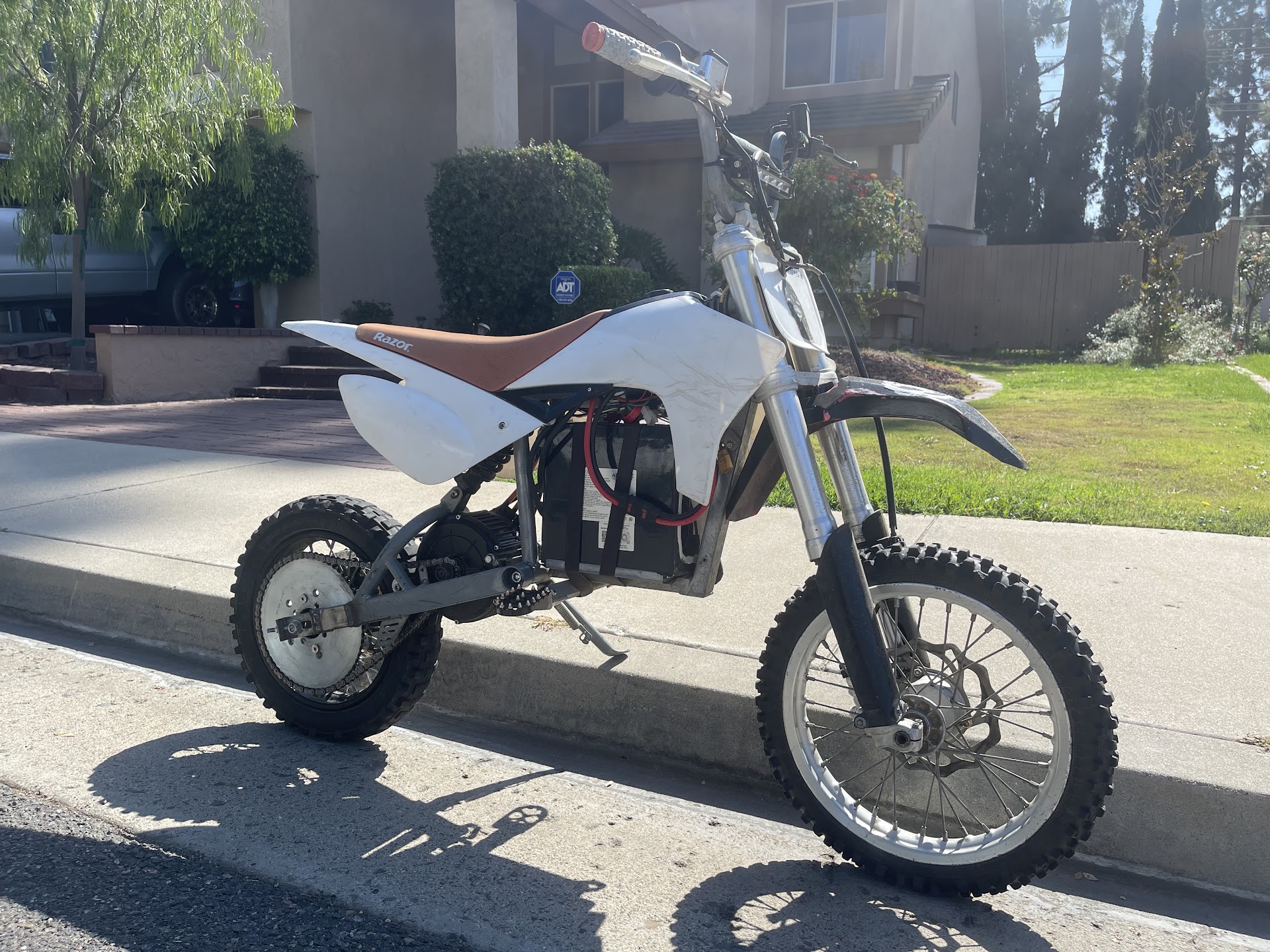 White electric dirt bike conversion outdoors