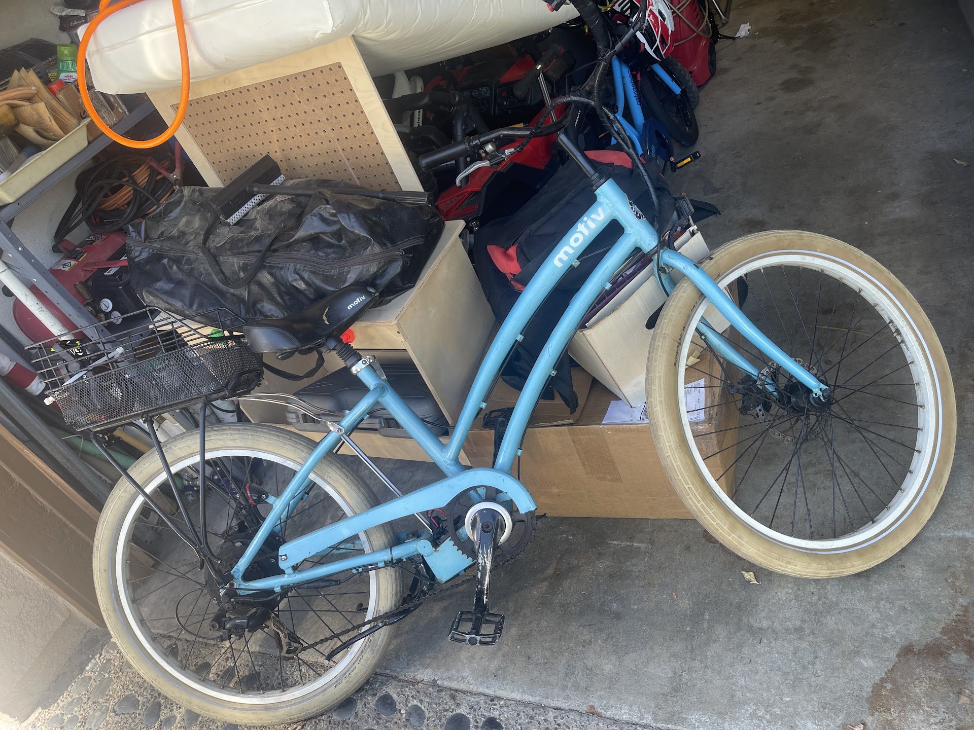 Blue step-through electric bicycle in the garage